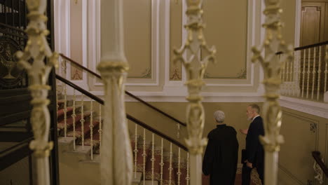 Formal Meeting on Grand Hotel Stairs
