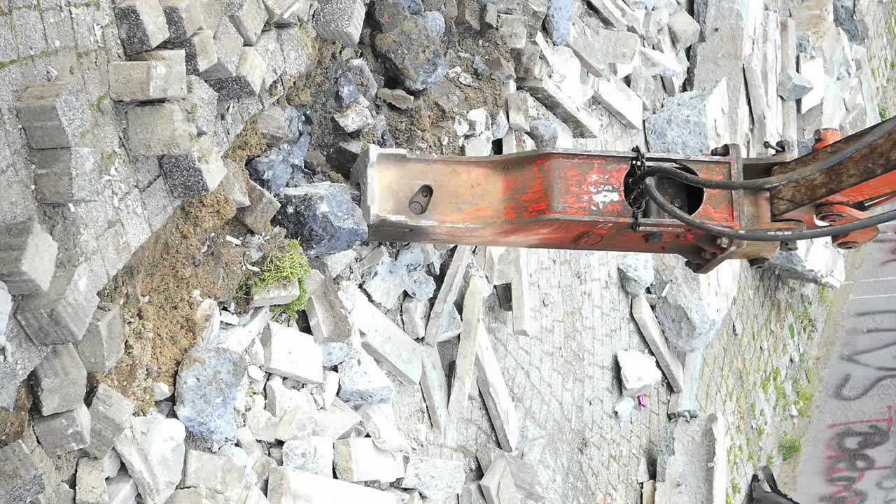 Jackhammer Demolishing Concrete Pavement