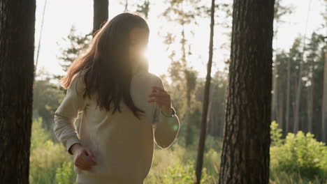 lady with long red hair runs in park at sunset. young woman performs cardio workout by jogging under sunlight in fresh air. training routine in evening