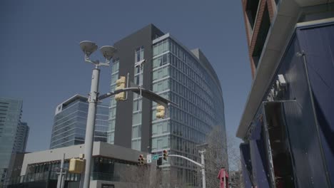 this wide shot captures a modern part of nashville, showing a mix of new architecture with the clear blue sky above