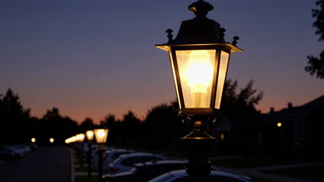 street lamp illuminating a residential street at dusk