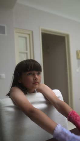 girl with gloves sitting at a table