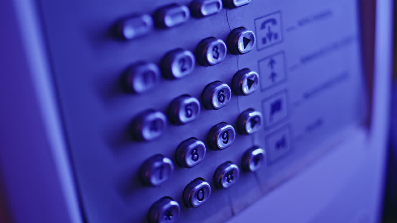 Lady fingers dialling phone number on public pay phone in neon light closeup