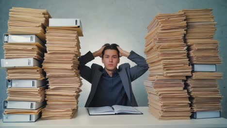 stressed businessman overwhelmed by paperwork in office