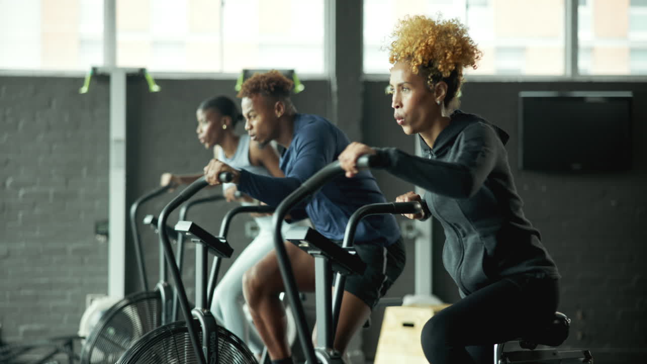 Woman Exercising on Stationary Bike in Gym