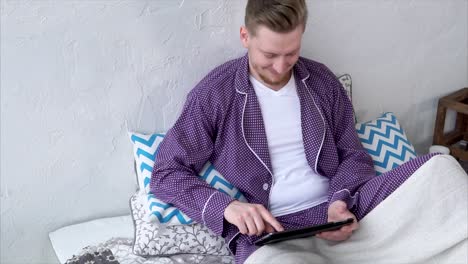 Man using tablet in bed