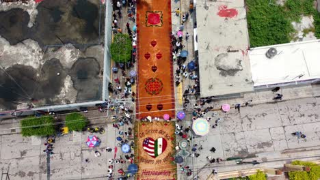 aerial footage of the colourful artistic sawdust carpets in huajuapan de leon, oaxaca, mexico during their annual celebration on july