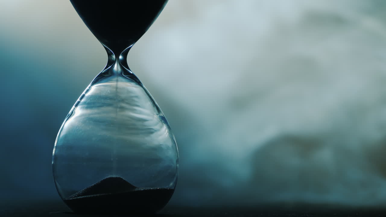 Detail of old hourglass grains of sand