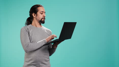 retrato de un hombre alegre revisando las publicaciones de las redes sociales en un cuaderno