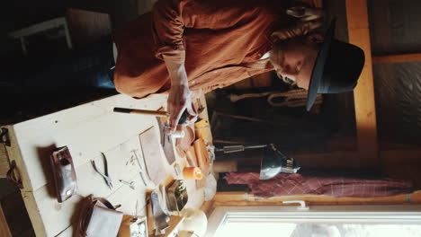 craftsman preparing tools in leather workshop