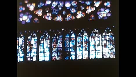 the sun shines through the rose window of the famous notre dame cathedral