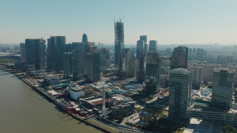 Skyline-of-Guangzhou-city-and-construction-of-skyscraper-in-Haizhu-District,-China,-aerial-view