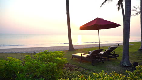 scene of beautiful tropical beach and sea at sunset with umbrella and deckchair lounge for holiday and travel