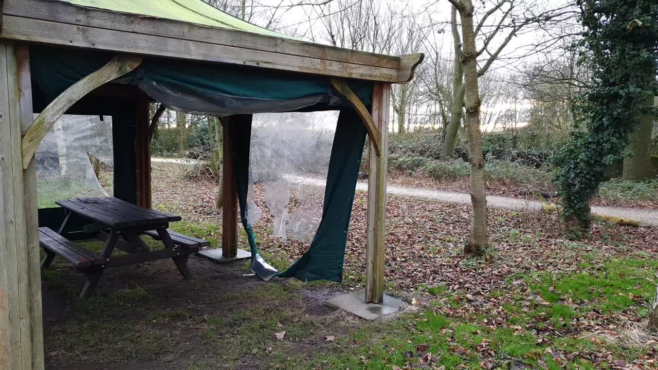 Damage after the storm on a local park torn awning, tent.
