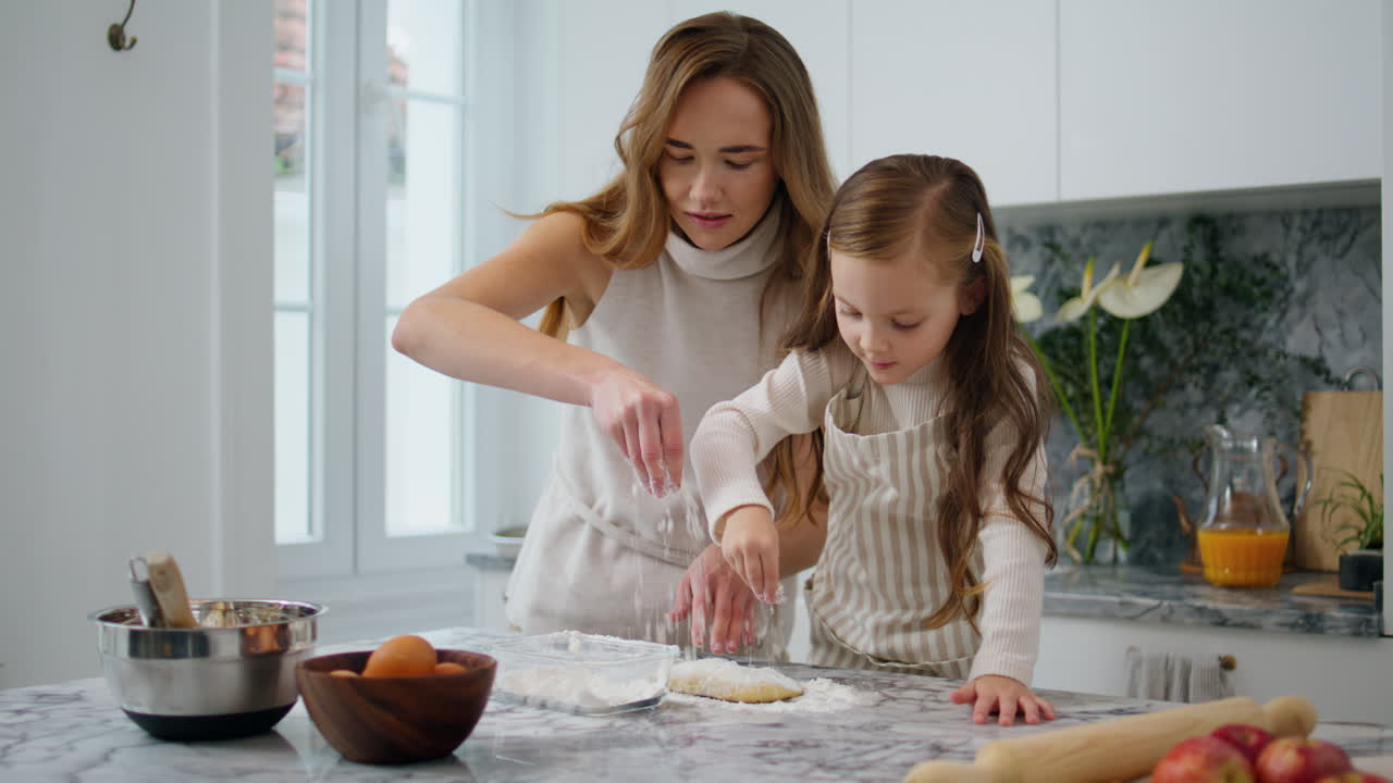 Cheerful woman pouring flour table indoors closeup. Sweet family preparing food