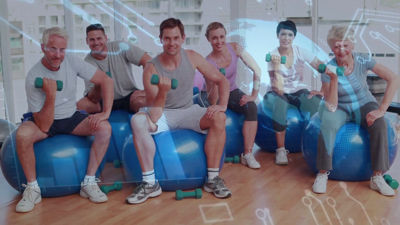 Curling class group sitting on stability balls on cue, lifting green dumbbells in exercise clothes