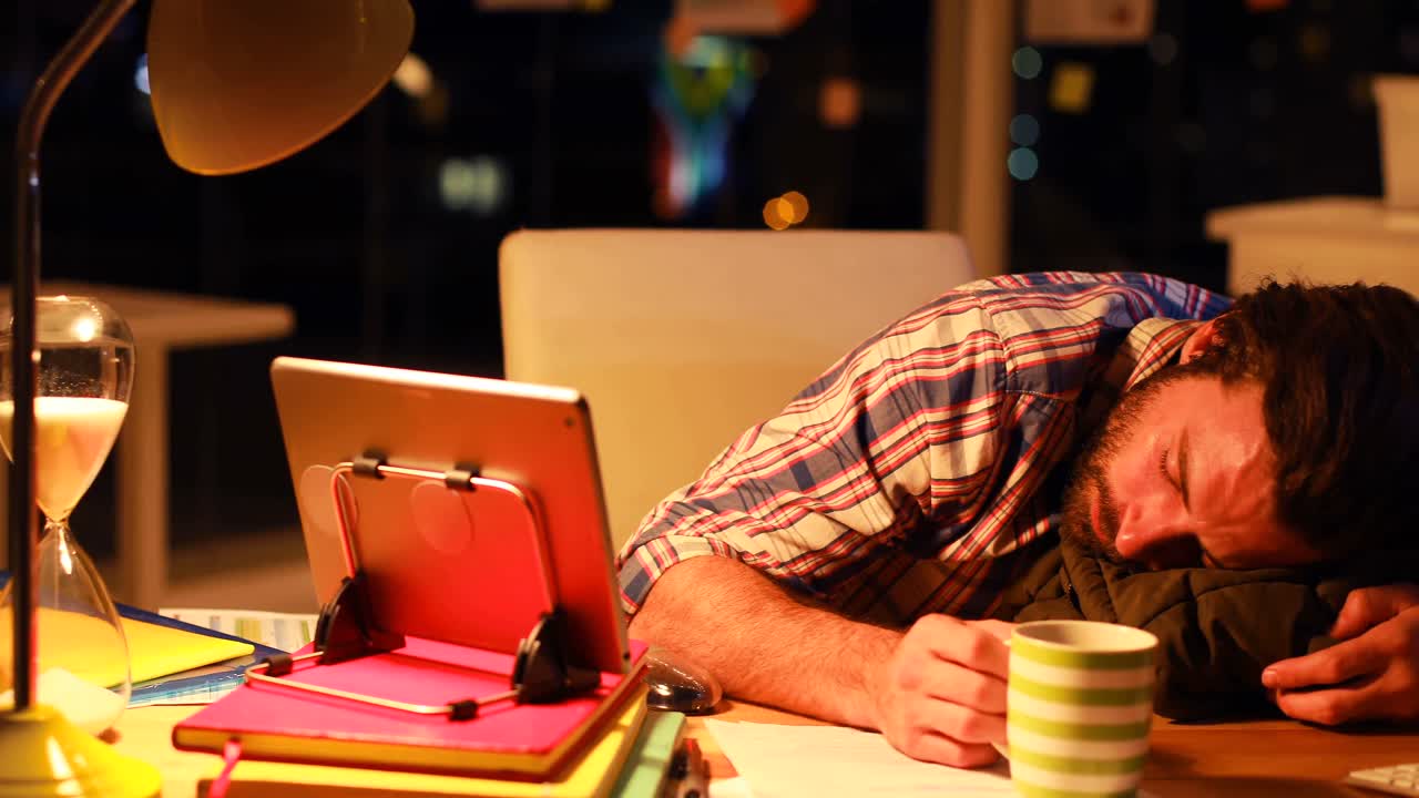 Business executive lying on his desk