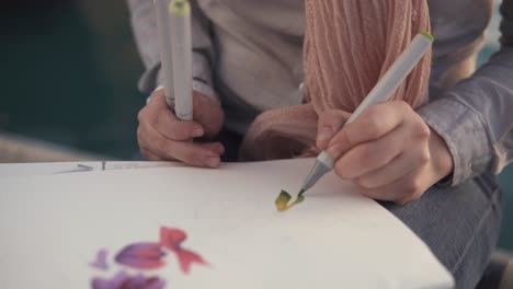 person drawing with markers