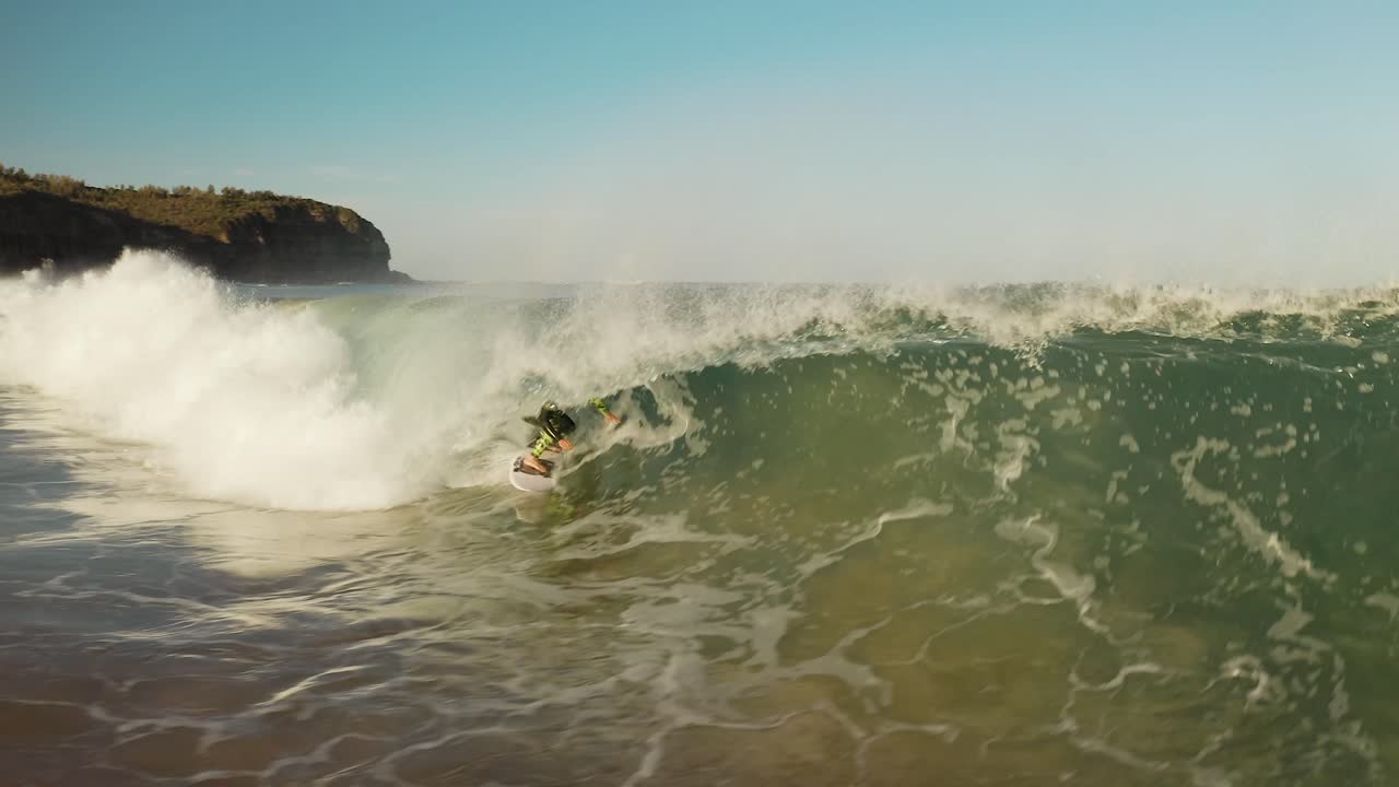 Surfer rides into barrel wave, surfing in Sydney, Australia aerial shot