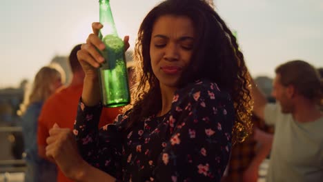 Laughing-afro-woman-dancing-with-raised-hands