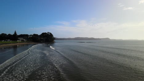 Cinematic-aerial-flight-over-shallow-water-at-Red-beach,-New-Zealand