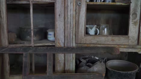 the cupboard contains damaged household items due to a volcanic eruption disaster