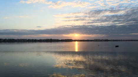 Aerial-footage-over-the-water-during-Sunset-at-Costa-Nova-Beach,-Portugal