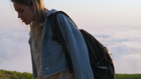 woman hiking in mountains at sunset