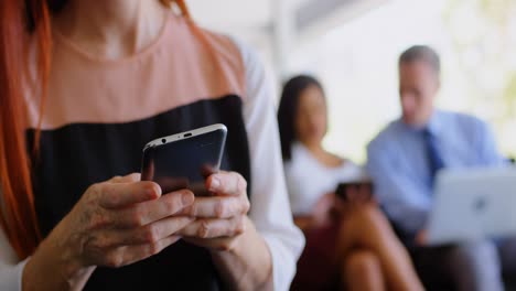 Businesswoman-using-mobile-phone-in-office-4k