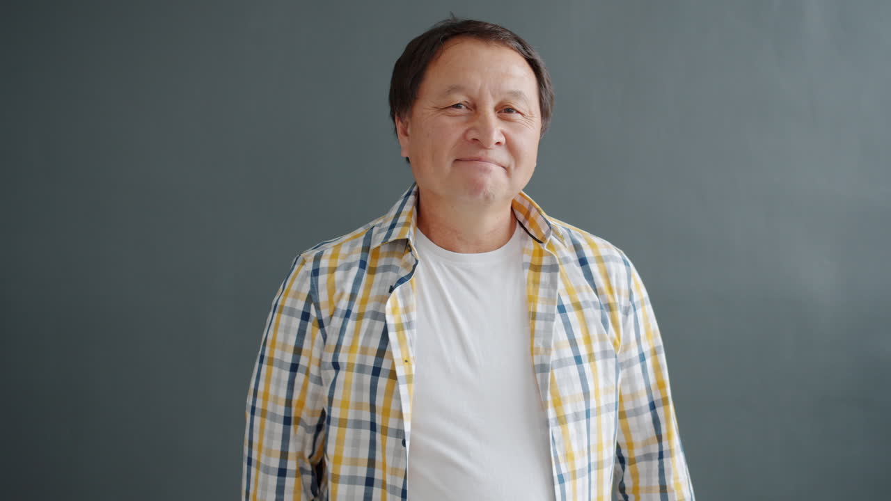 Smiling Asian Man with Thumbs Up