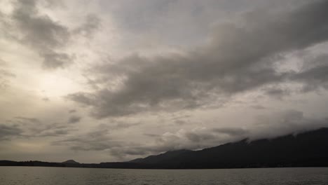 dramatic gray storm clouds criss cross lake quinalt olympic national forest, time lapse