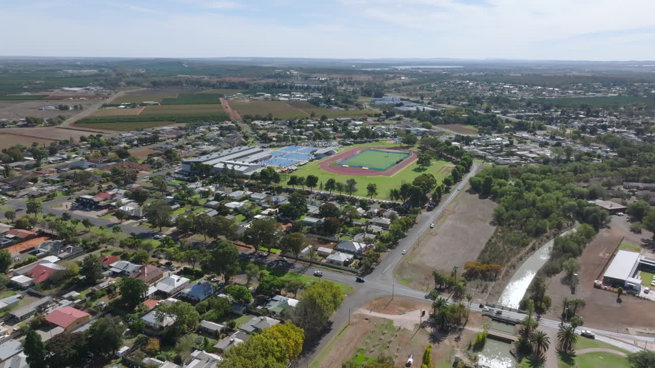 Aerial: Wide shot of athletics tracks and sports facilities in Griffith, NSW Australia