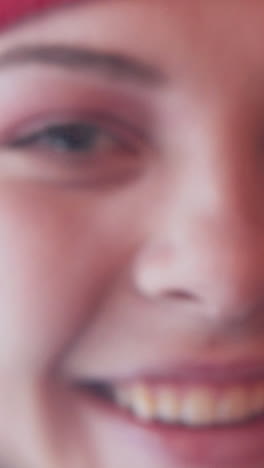 cheerful elf girl looking at the camera through a magnifying glass. close-up. vertical video