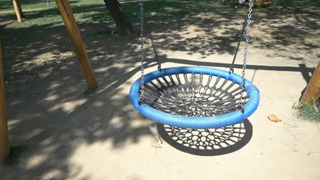 empty blue swing in a park