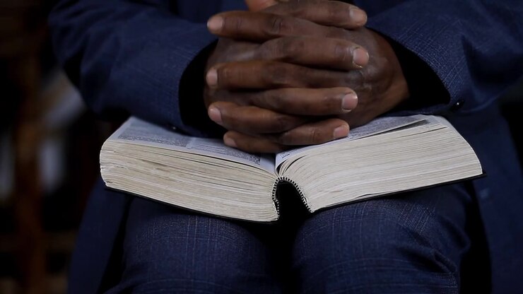 praying to God with hand on bible with people stock video stock footage