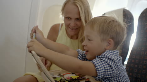 mother and son playing game in the plane