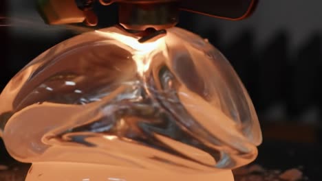 captivating moment of glass shaping: an artistic display of sculpting techniques highlighting the elegance and fluidity in glass craftsmanship