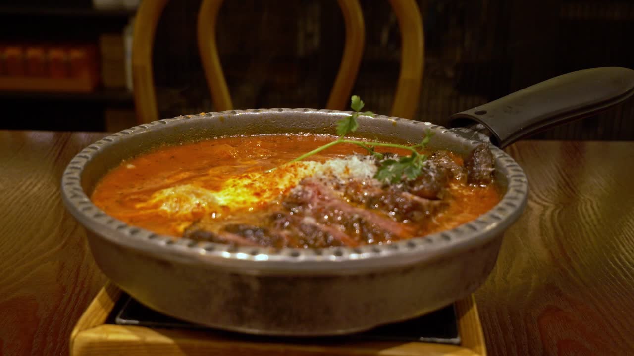 Pot Of Beef Steak Shakshuka Dish Served On The Table In The Middle Eastern Restaurant. - closeup shot