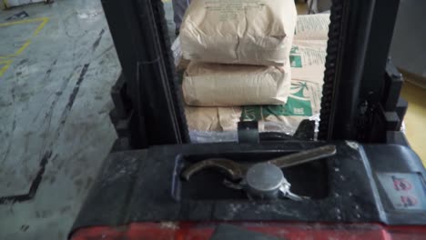 forklift loading bags in a warehouse