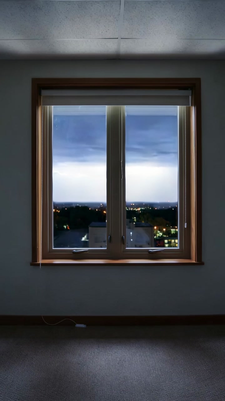 Vertical video: Filming fixed camera capturing wooden window at night, lightning lighting skyline