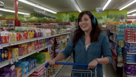 happy woman shopping in a supermarket with headphones