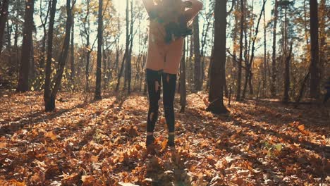 woman playing in an autumn forest