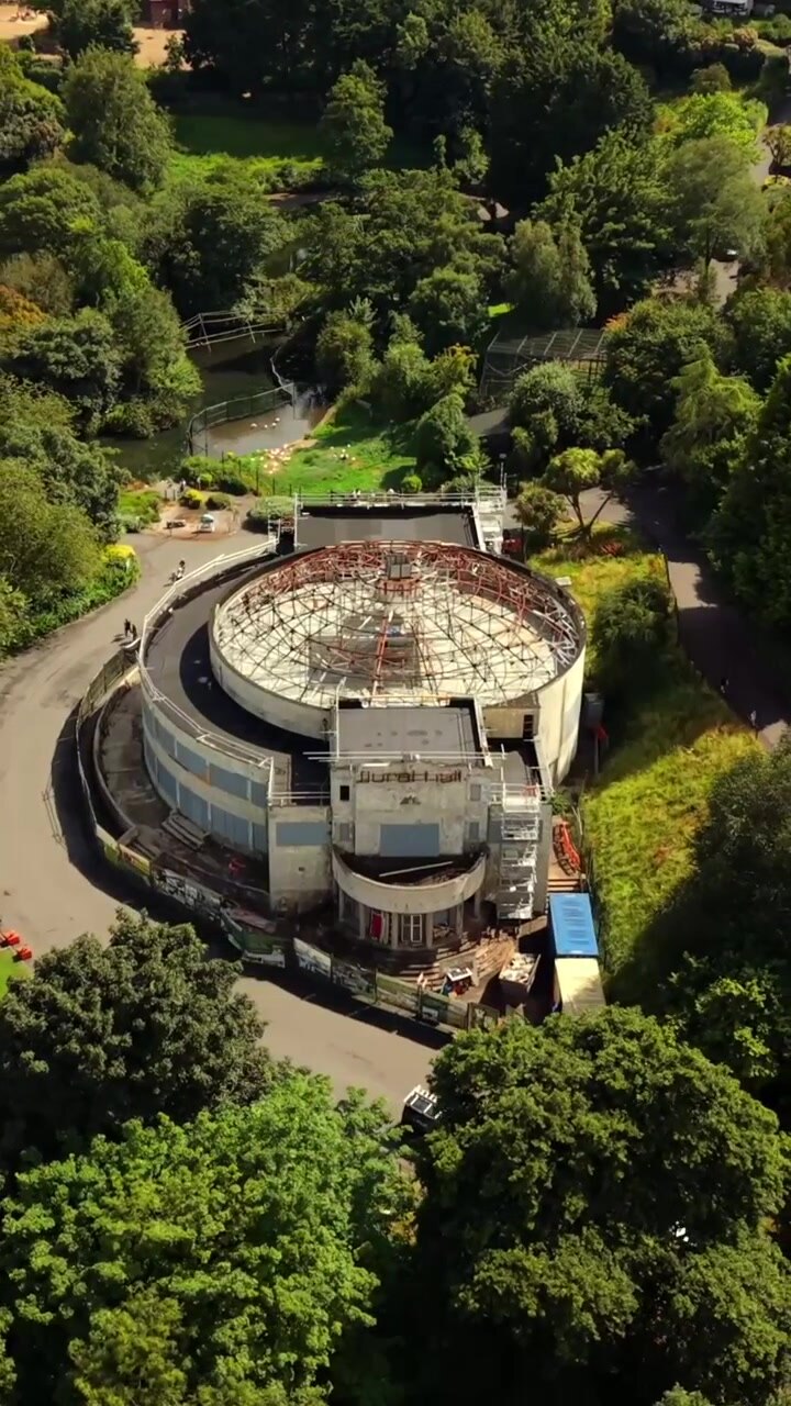 Rotating overhead 60FPS vertical social ratio aerial video of Belfast Zoo and Cavehill in North Belfast, Northern Ireland in the UK on a bright sunny day. Produced with Rec709 colour.