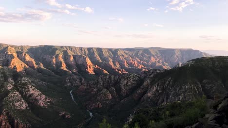 in the distance a drone flies off over a red rock canyon, sedona, arizona