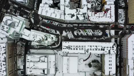 vista aérea sobre calles mojadas y tejados nevados en varsovia, nublado, día de invierno en polonia - de arriba hacia abajo, disparo de drones