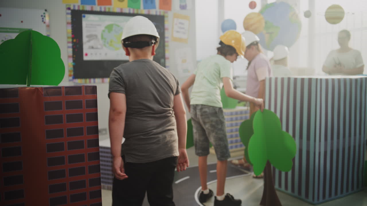 Team of Primary School Students in Hardhats Creating City Planning