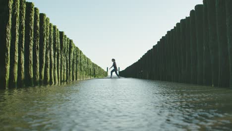 Woman-passing-through-Dutch-wave-breakers