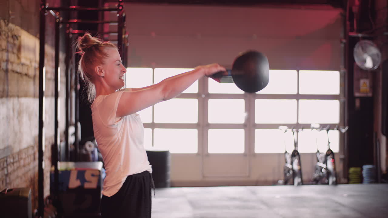 Side View Of Young Woman Exercising On Cable Machine At Fitness Club 5
