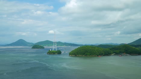 white lattice tower on an islet by the calm sea at daytime in geojedo island, south korea