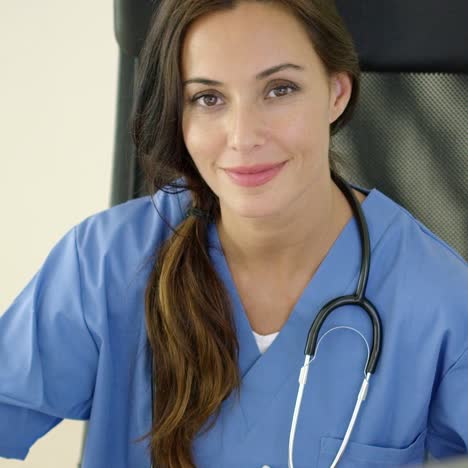 Young-female-physician-places-one-hand-on-her-face